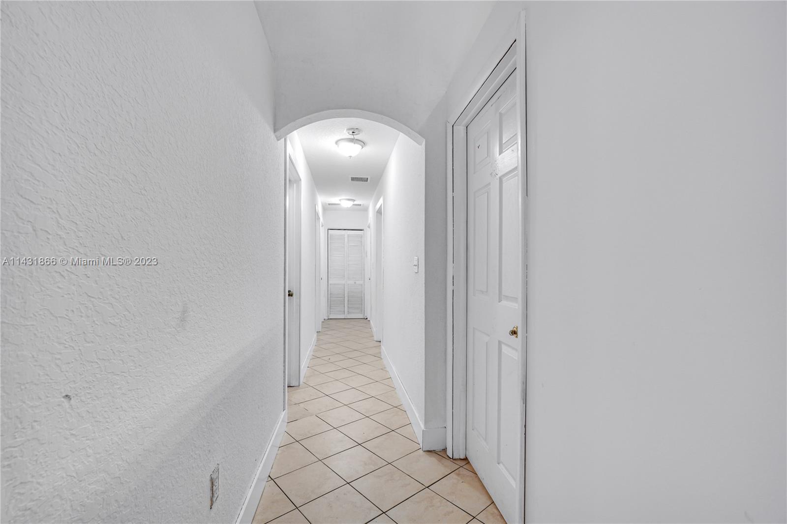 24313 Southwest 130th Avenue Homestead, FL 33032 - Photo 9 of 23 a view of a hallway with wooden floor