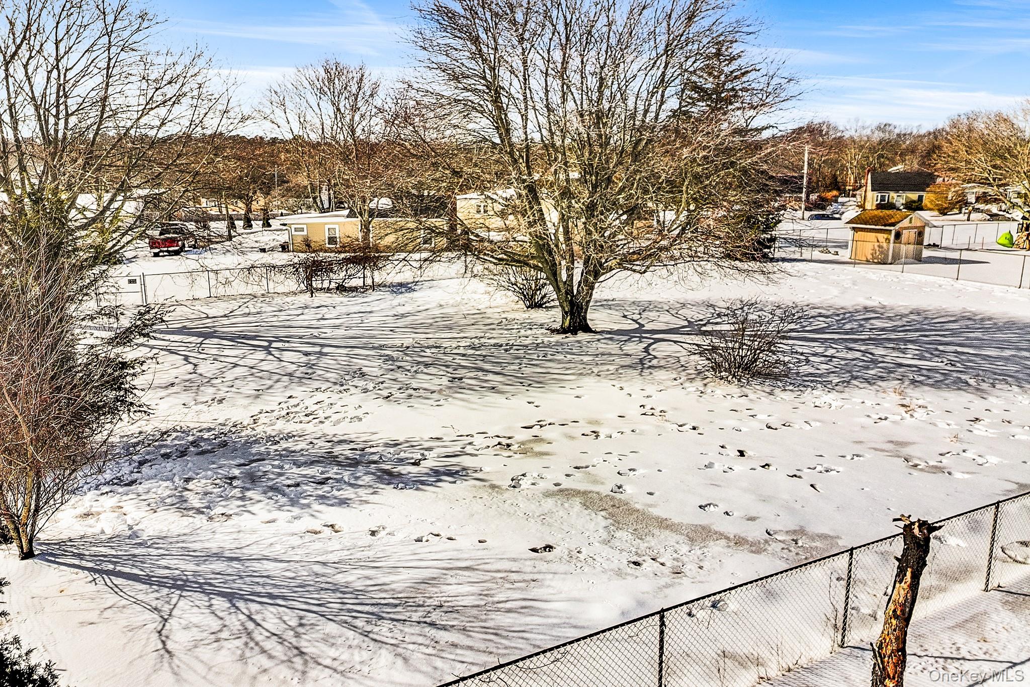 257 Doctors Path Riverhead, NY 11901 - Photo 18 of 18 a view of a yard with snow on the road
