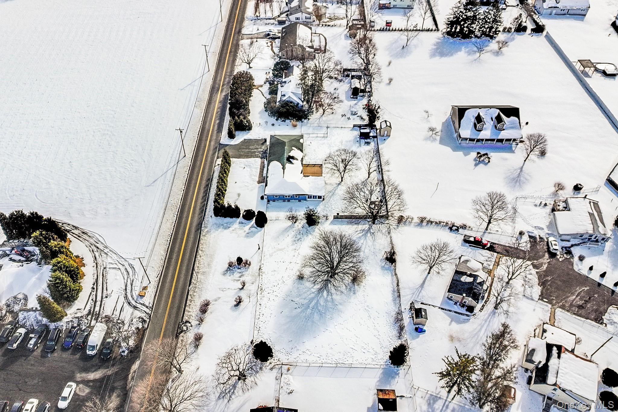 257 Doctors Path Riverhead, NY 11901 - Photo 5 of 18 an aerial view of residential house with parking