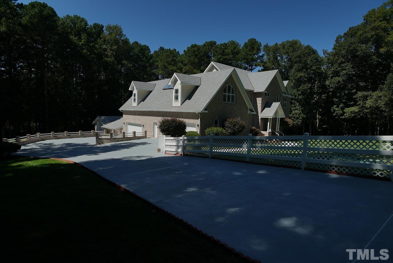 6007 Graystone Drive Chapel Hill, NC 27514 - Photo 28 of 30 Paved driveway leads to the side-entry garages.