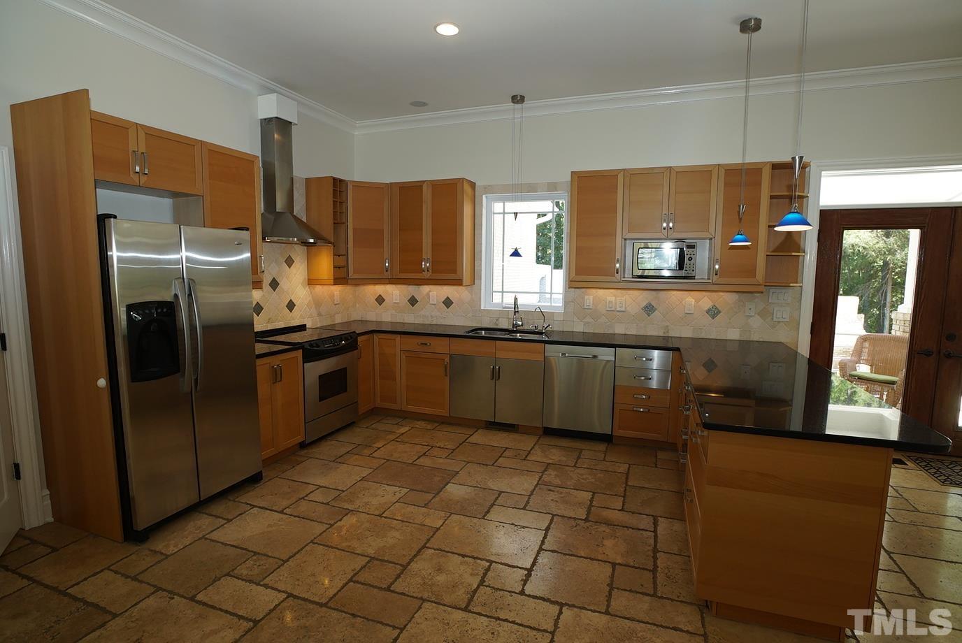 6007 Graystone Drive Chapel Hill, NC 27514 - Photo 4 of 30 Kitchen with stainless-steel appliances, granite counter tops, tile backsplash.