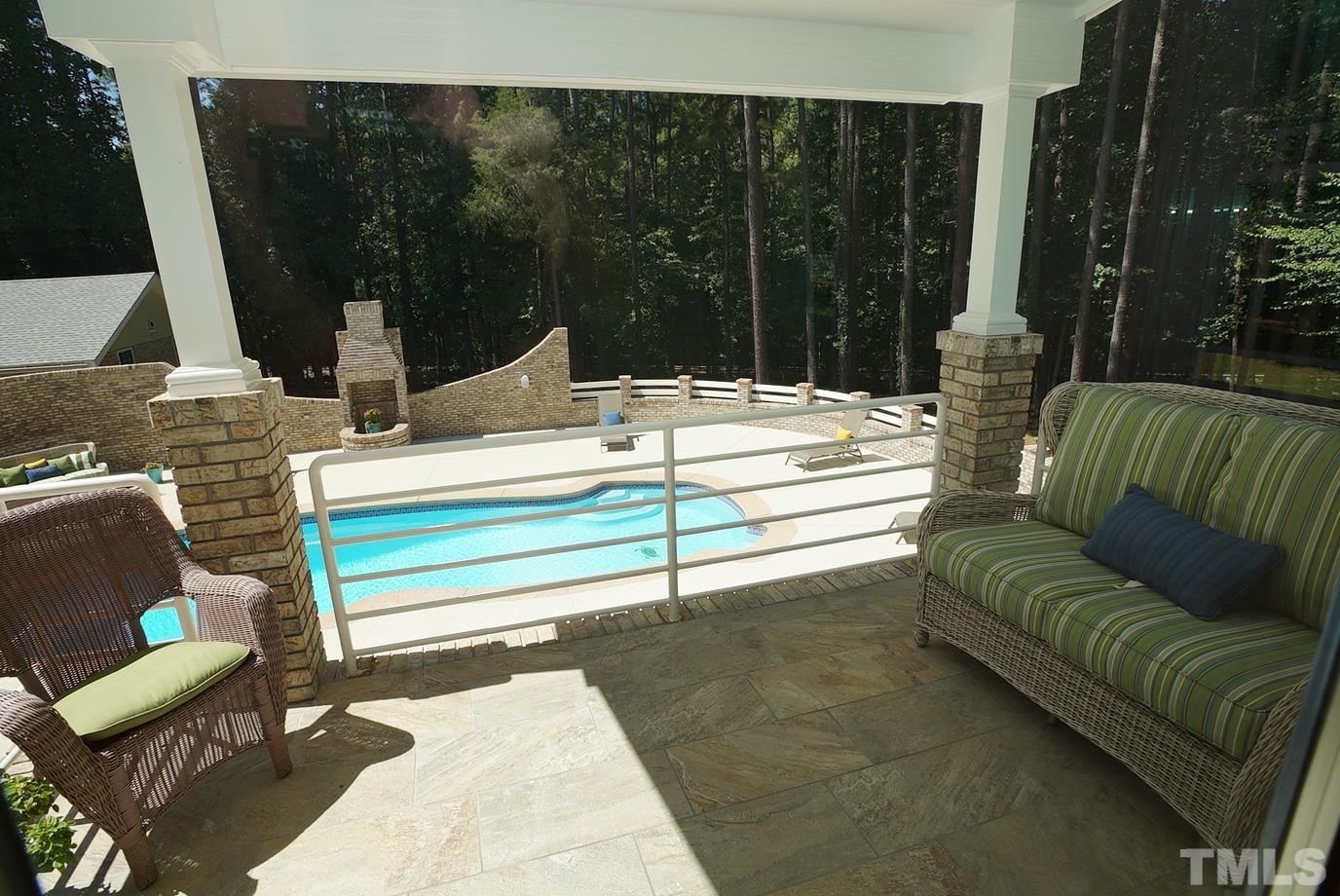 6007 Graystone Drive Chapel Hill, NC 27514 - Photo 6 of 30 Primary bedroom has a balcony that overlooks the pool and woods.