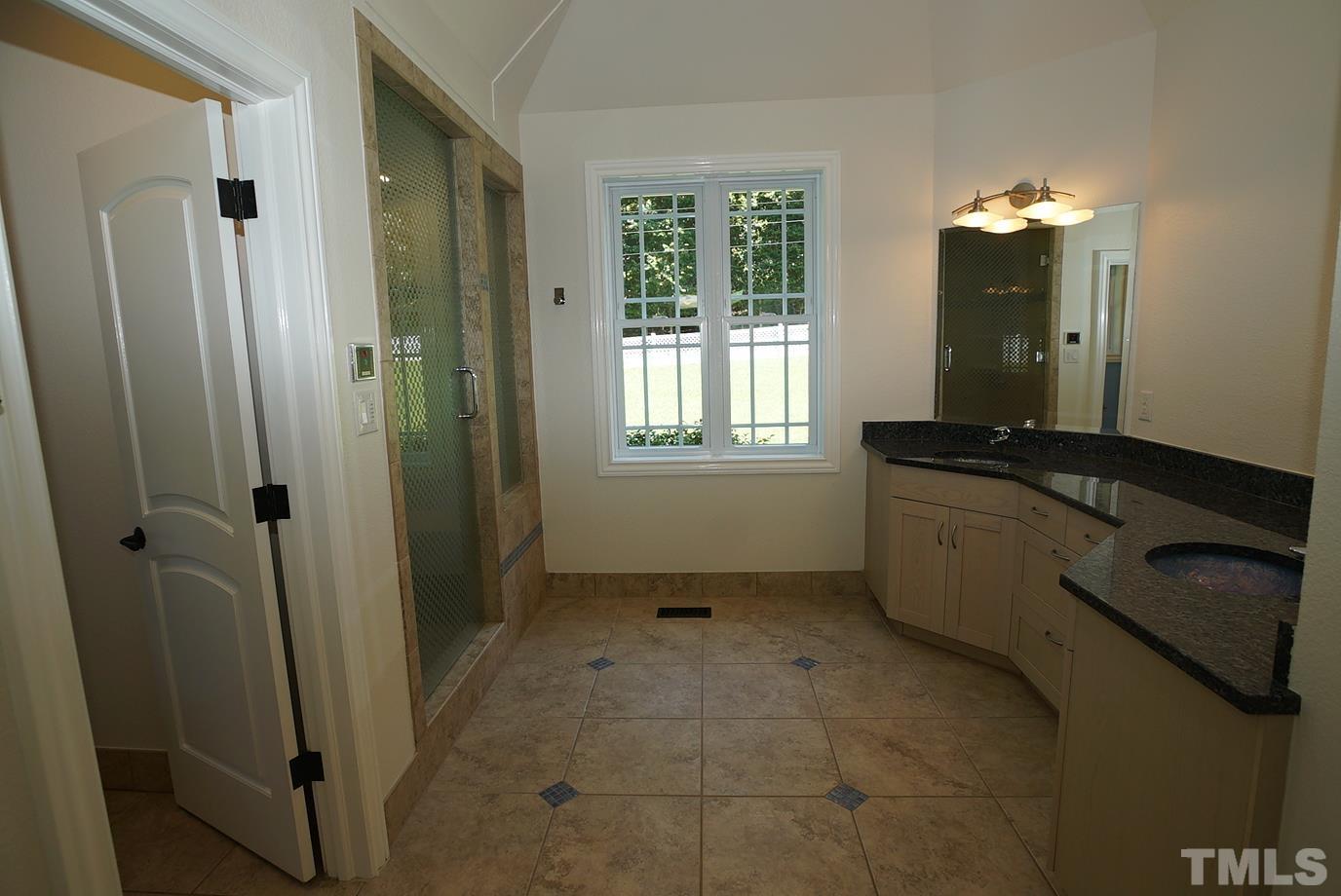 6007 Graystone Drive Chapel Hill, NC 27514 - Photo 7 of 30 Primary bath with walk-in steam shower, double vanity with granite counter tops, separate water closet.