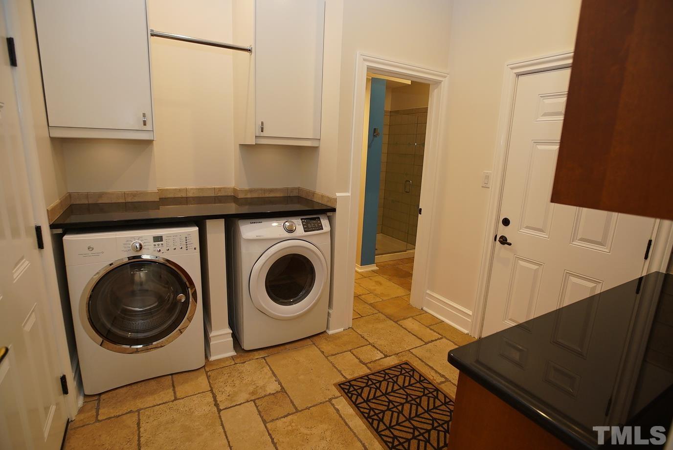 6007 Graystone Drive Chapel Hill, NC 27514 - Photo 10 of 30 Laundry room is adjacent to the kitchen and opens to both 2-car garages. Good pantry storage space. Full bath with shower ideal for pool guests.