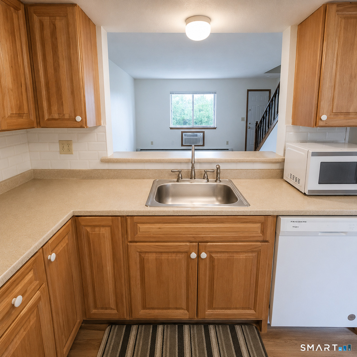 975 Meriden Road, Unit 101 Waterbury, CT 06705 - Photo 18 of 28 a kitchen with a sink cabinets and a window