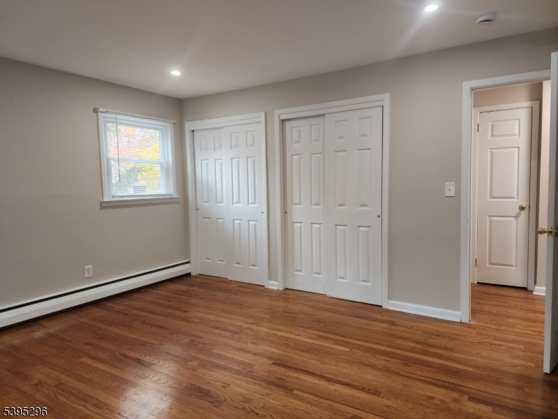 84 Reservoir Avenue Butler, NJ 07405 - Photo 11 of 20 an empty room with wooden floor and windows