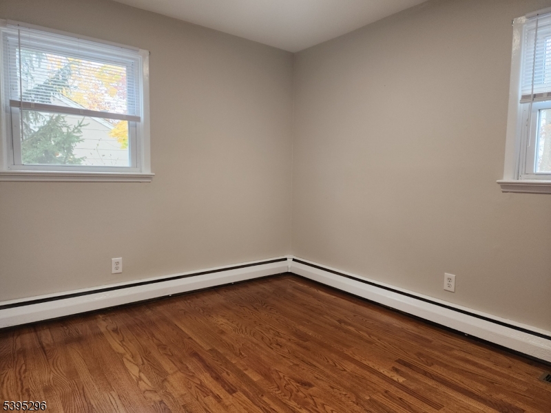 84 Reservoir Avenue Butler, NJ 07405 - Photo 13 of 20 an empty room with wooden floor and windows