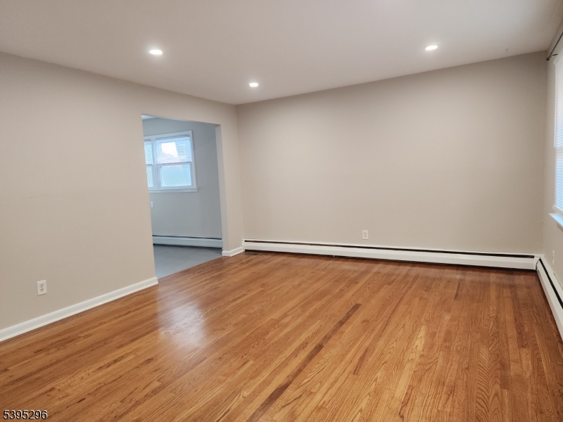 84 Reservoir Avenue Butler, NJ 07405 - Photo 4 of 20 a view of room with wooden floor and fan