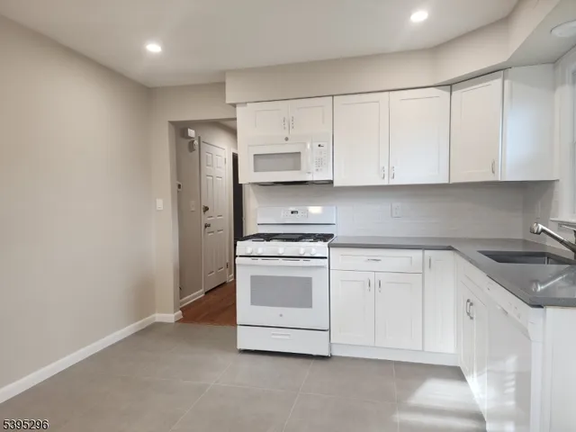 a kitchen with stainless steel appliances granite countertop a sink and a stove