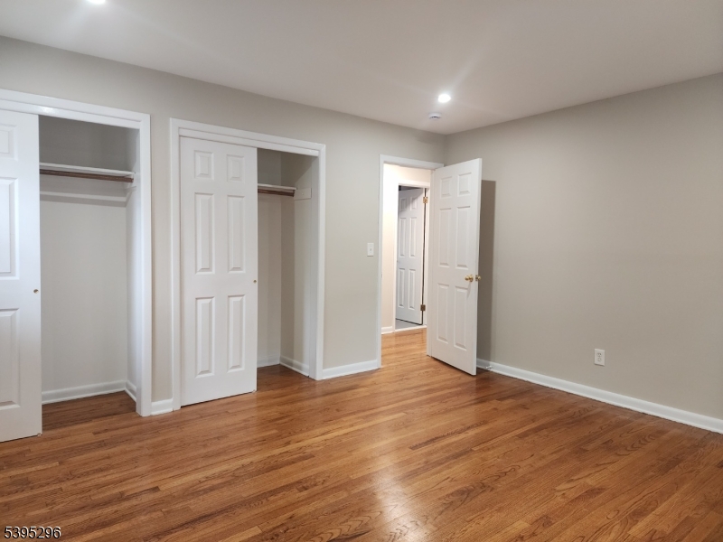 84 Reservoir Avenue Butler, NJ 07405 - Photo 10 of 20 an empty room with wooden floor & closet area
