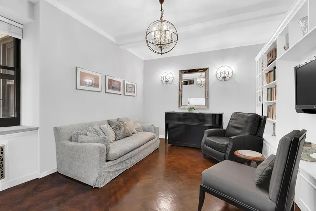 a living room with furniture flat screen tv and window