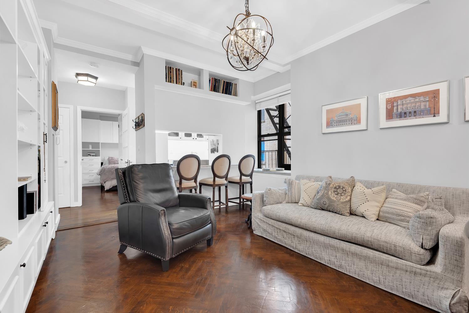 375 Riverside Drive, Unit 7G Manhattan, NY 10025 - Photo 6 of 7 a living room with furniture or couch and a chandelier