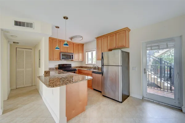 a kitchen with refrigerator and cabinets