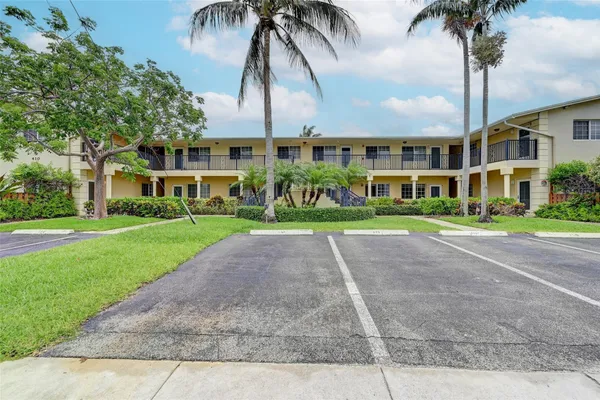 a front view of multiple houses with yard