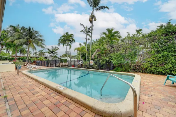a view of swimming pool with outdoor seating and plants