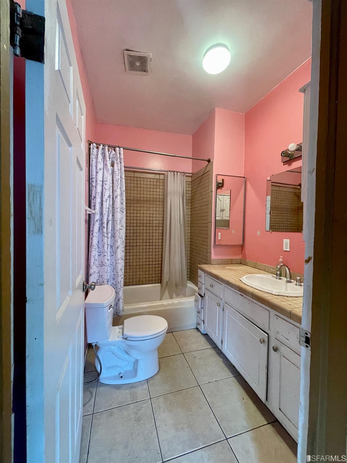 1022 24th Street Oakland, CA 94607 - Photo 7 of 9 a bathroom with a bathtub shower sink mirror and toilet