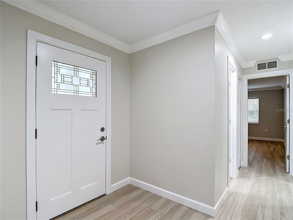 4536 Mitcher Road New Port Richey, FL 34652 - Photo 8 of 46 a view of a hallway with wooden floor and a bathroom