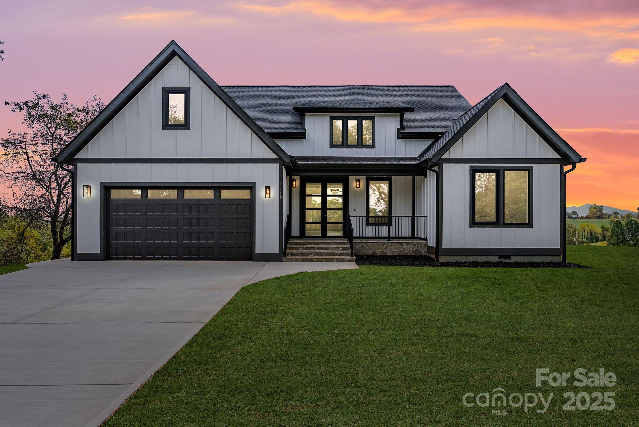a front view of a house with a yard and garage