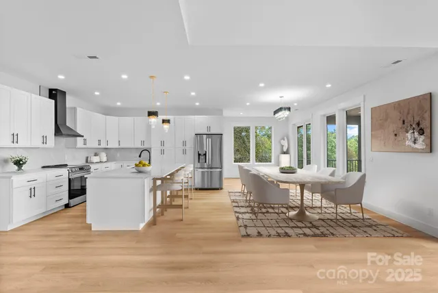 a large kitchen with stainless steel appliances granite countertop a large center island and a window