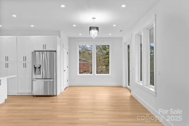 a kitchen with stainless steel appliances granite countertop a sink a stove a refrigerator and cabinets