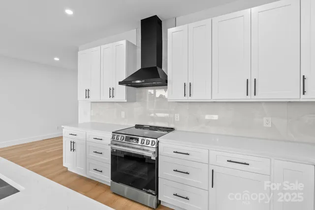 a kitchen with stainless steel appliances granite countertop a sink and a refrigerator