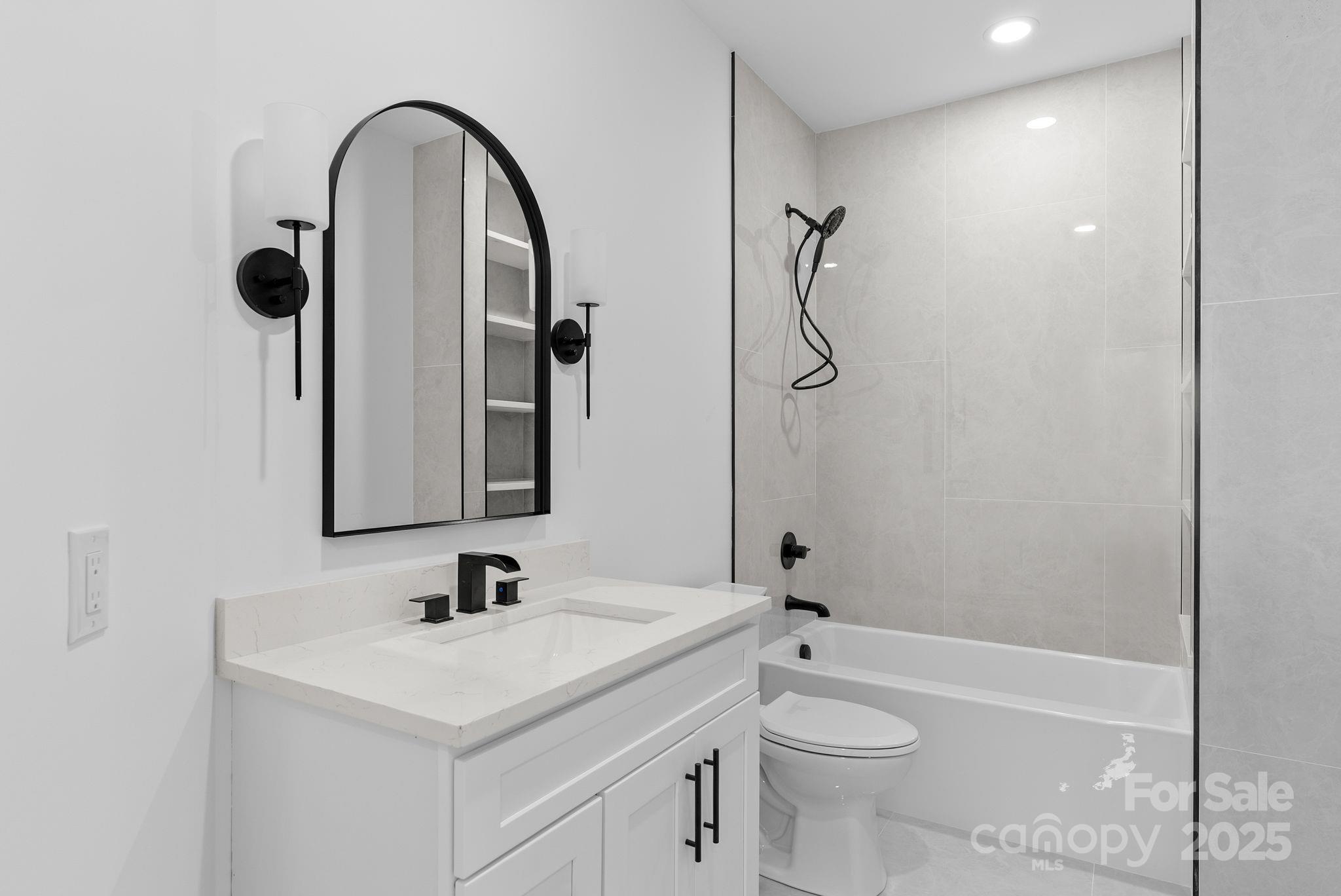 1148 Alexander Road Leicester, NC 28748 - Photo 19 of 47 a bathroom with a granite countertop sink a toilet and a mirror