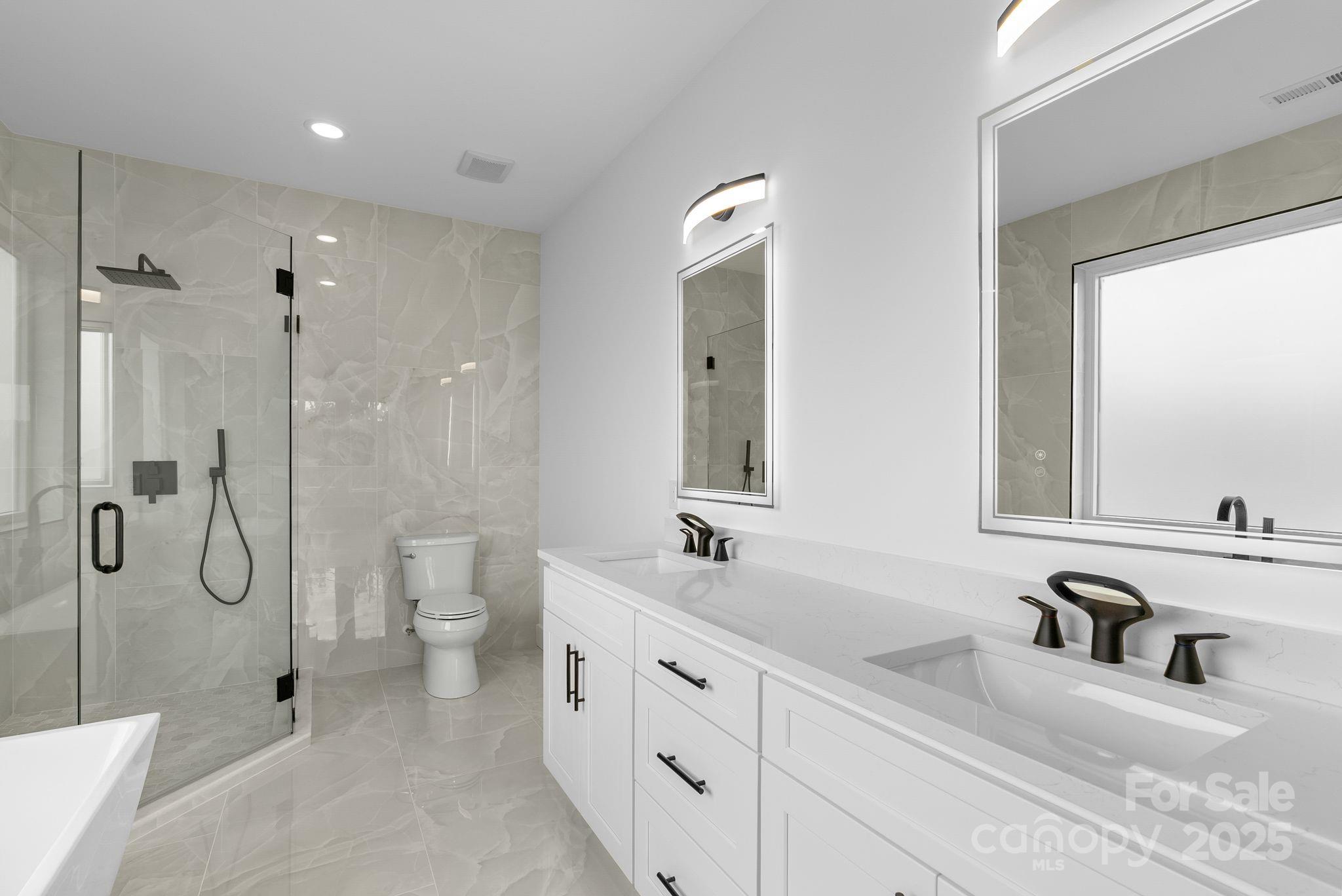 1148 Alexander Road Leicester, NC 28748 - Photo 25 of 47 a bathroom with a double vanity sink mirror double and shower