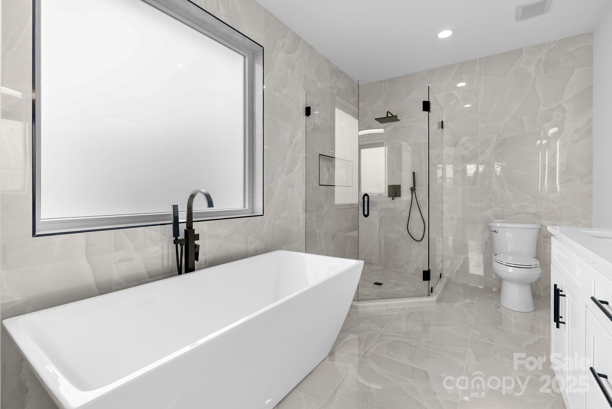 1148 Alexander Road Leicester, NC 28748 - Photo 26 of 47 a bathroom with a tub a toilet and a shower