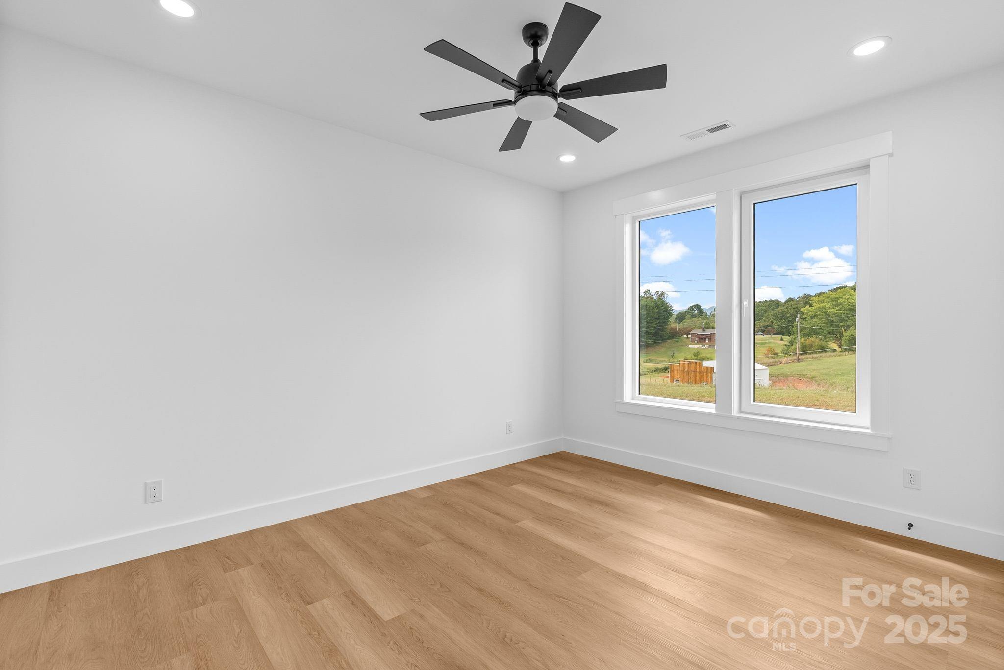 1148 Alexander Road Leicester, NC 28748 - Photo 28 of 47 an empty room with a window and a fan