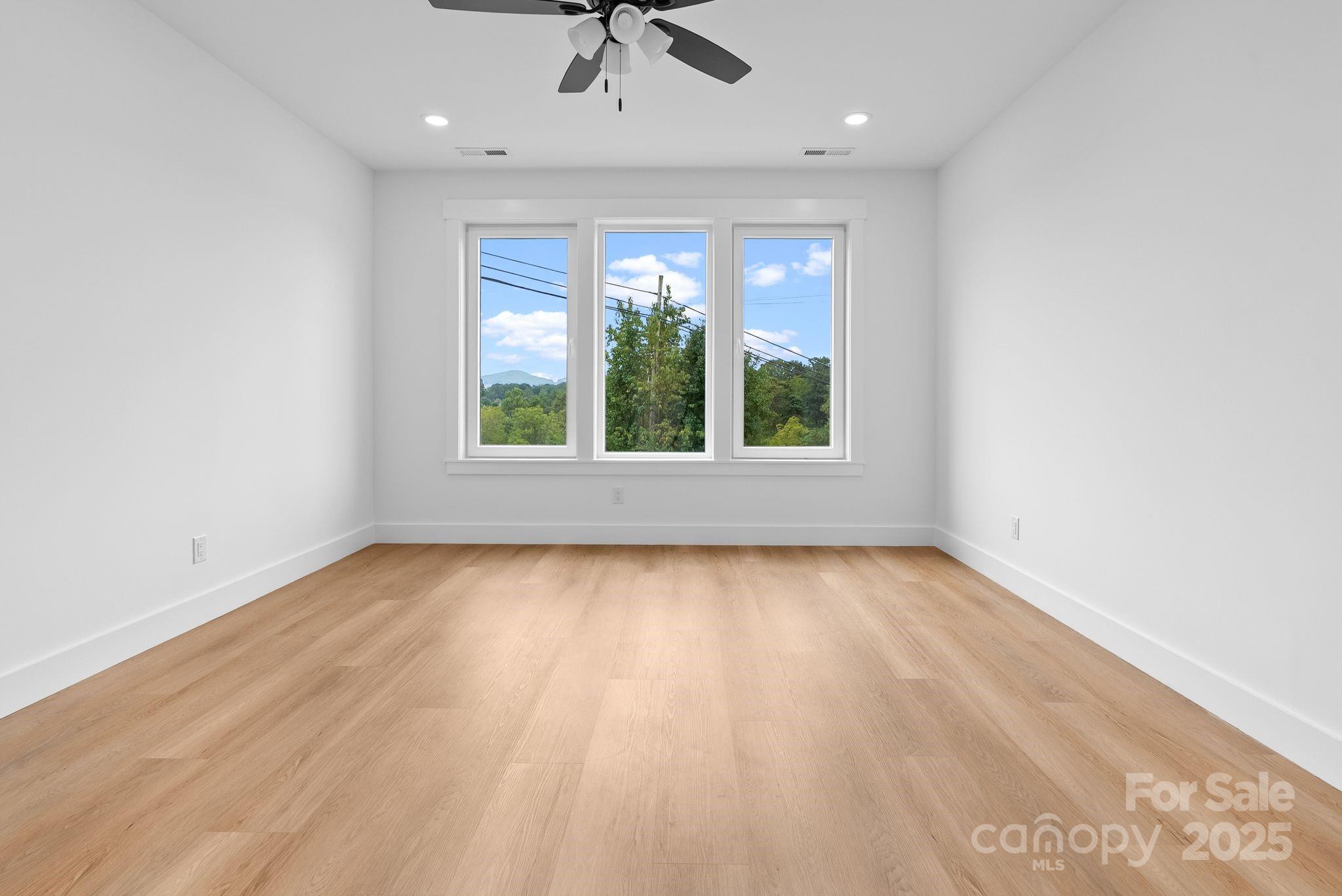 1148 Alexander Road Leicester, NC 28748 - Photo 33 of 47 an empty room with wooden floor and windows