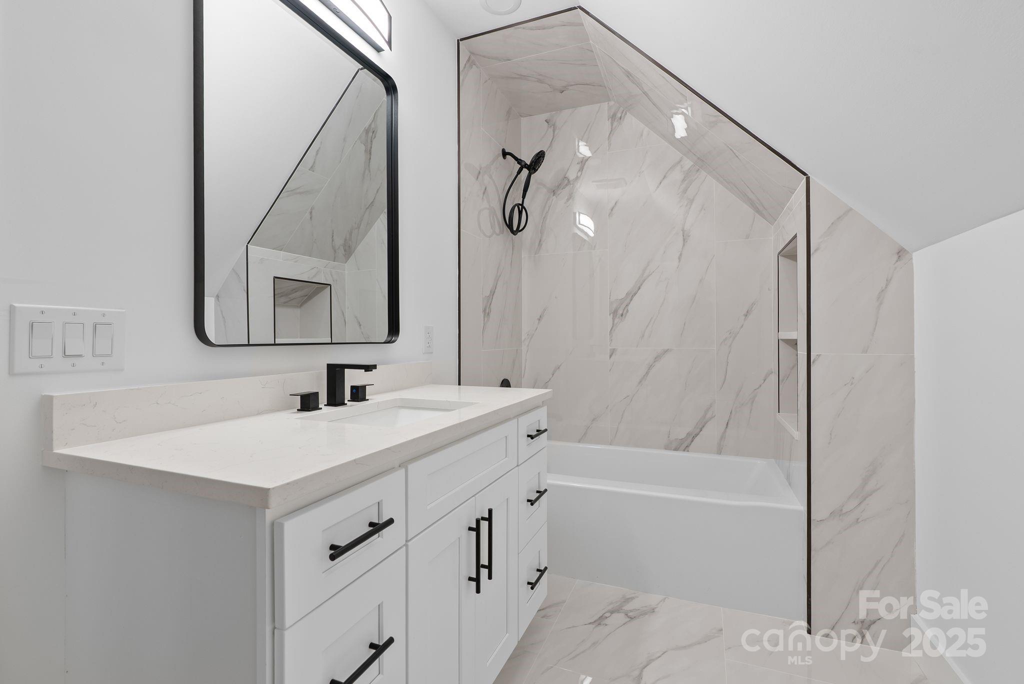 1148 Alexander Road Leicester, NC 28748 - Photo 38 of 47 a bathroom with a tub sink and mirror