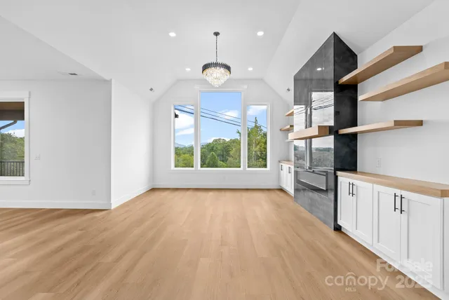 a living room with furniture fireplace and a view of kitchen