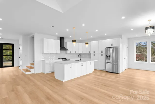 a living room with a kitchen island furniture and a kitchen view