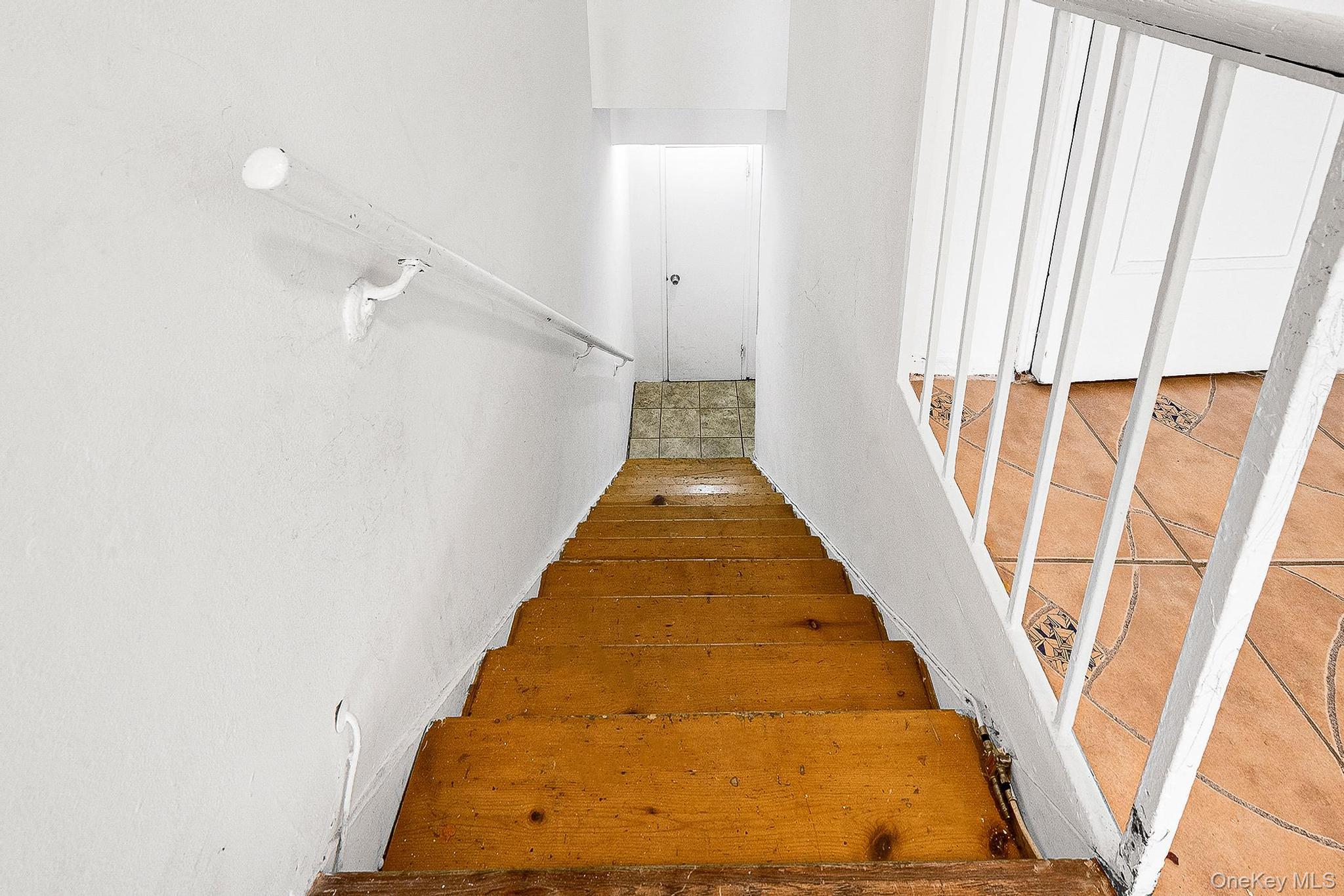99-32 66th Road, Unit 5B Queens, NY 11374 - Photo 23 of 27 Stairway with hardwood / wood-style floors