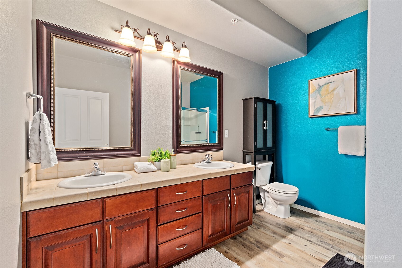 14915 38th Drive Southeast, Unit 2049 Bothell, WA 98012 - Photo 15 of 25 a bathroom with a double vanity sink toilet and mirror