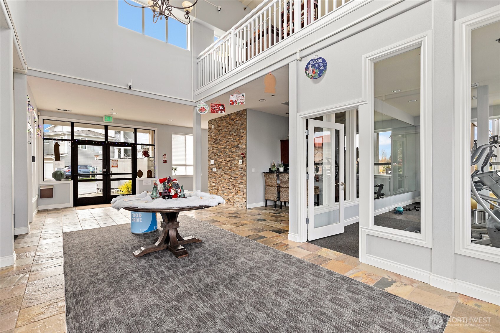14915 38th Drive Southeast, Unit 2049 Bothell, WA 98012 - Photo 29 of 36 a living room with furniture a table and large windows