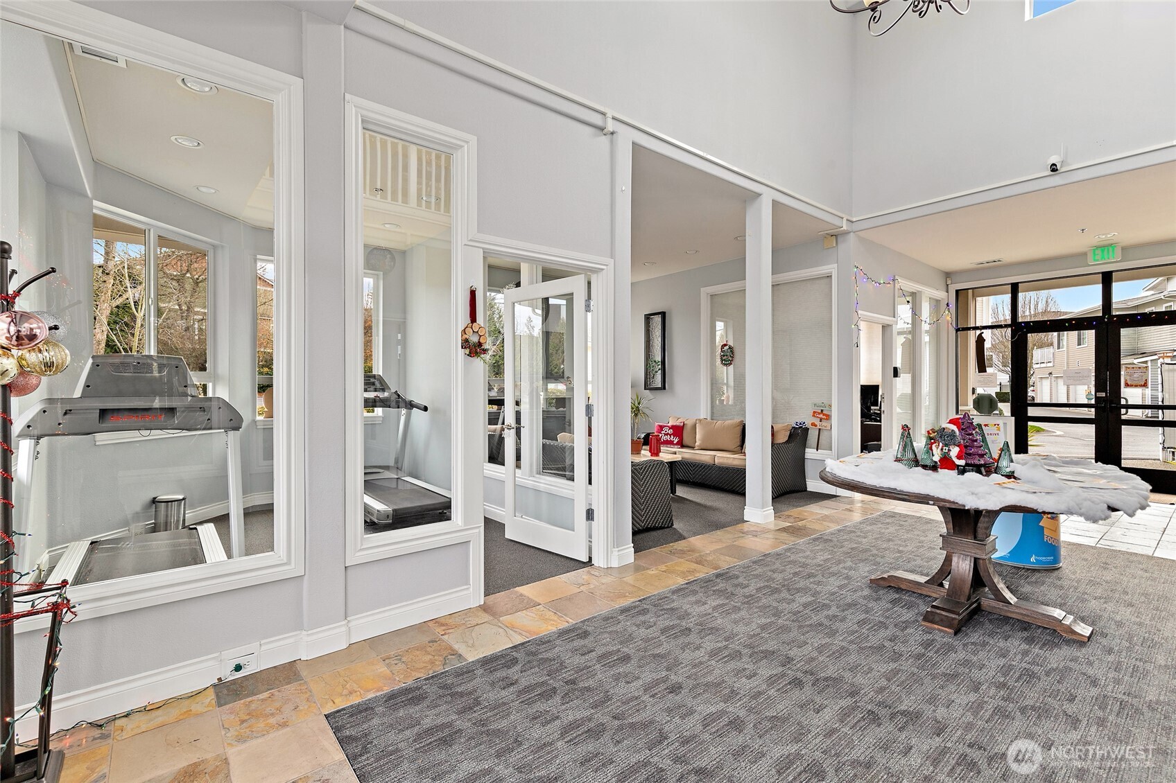 14915 38th Drive Southeast, Unit 2049 Bothell, WA 98012 - Photo 30 of 36 a living room with furniture a flat screen tv and a table