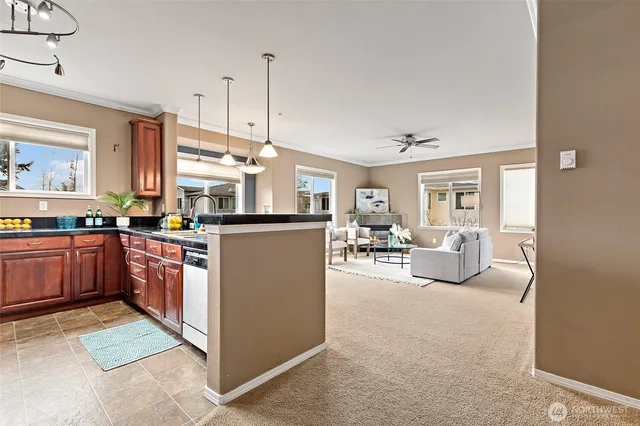 a kitchen with cabinets and chairs