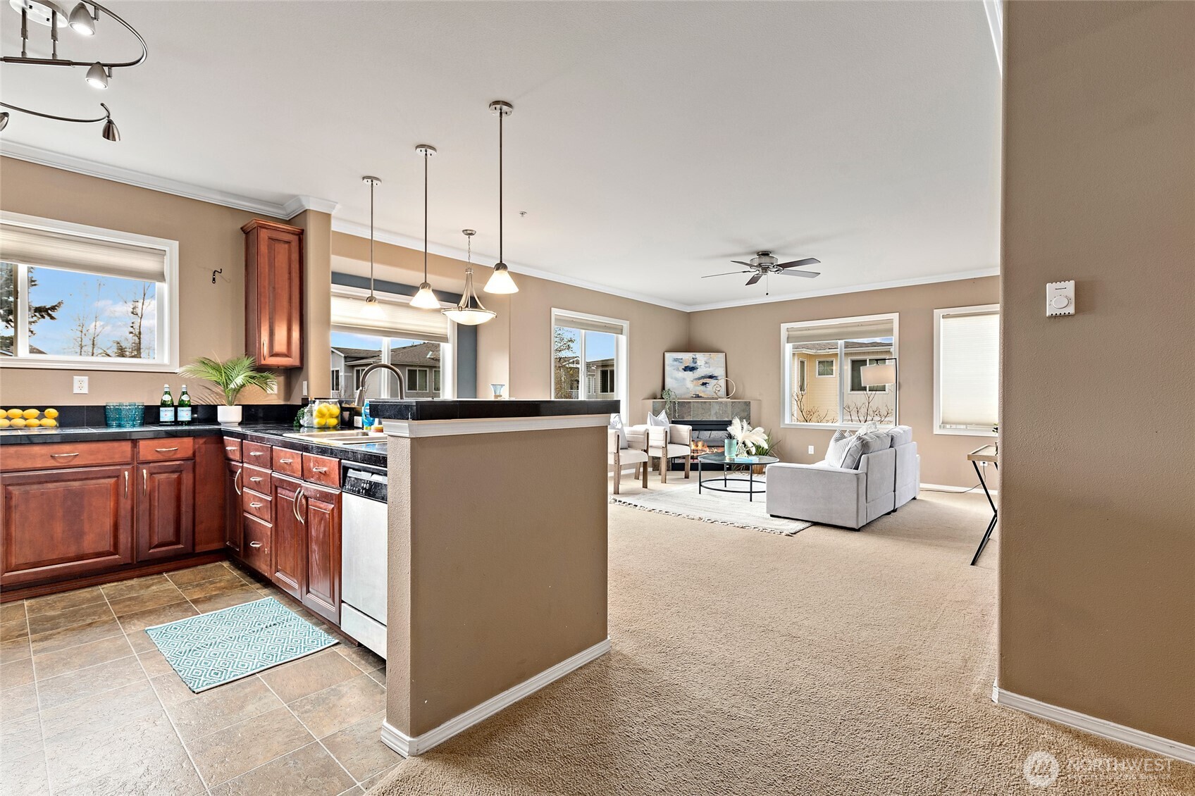 14915 38th Drive Southeast, Unit 2049 Bothell, WA 98012 - Photo 4 of 25 a kitchen with cabinets and chairs