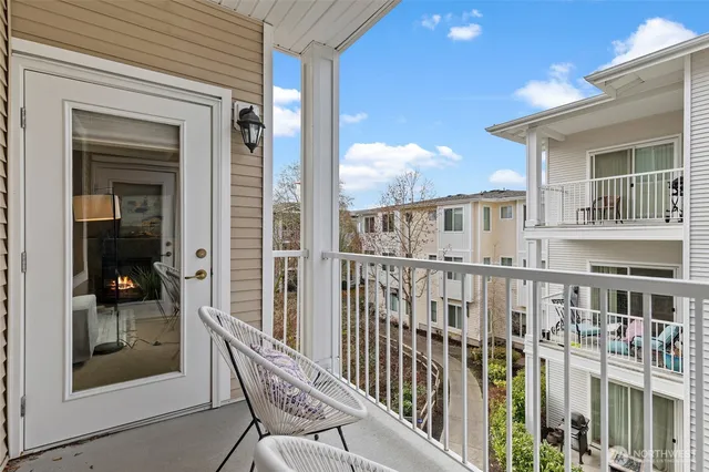 a view of a balcony with a barbeque