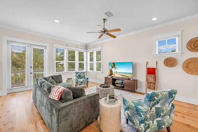 a view of dining room and livingroom with furniture wooden floor a chandelier