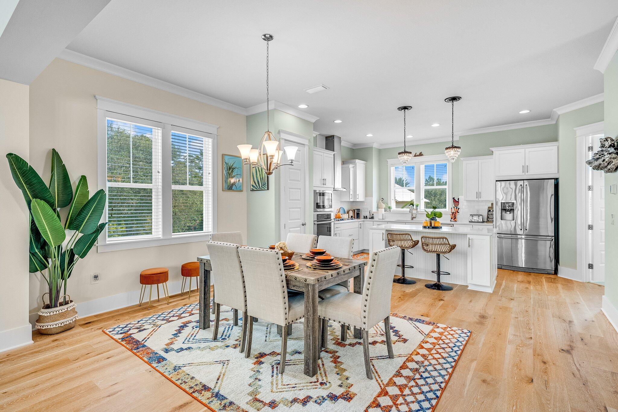 79 Grande Pointe Drive Inlet Beach, FL 32461 - Photo 19 of 47 a outdoor kitchen with stainless steel appliances kitchen island granite countertop a dining table chairs and a living room view