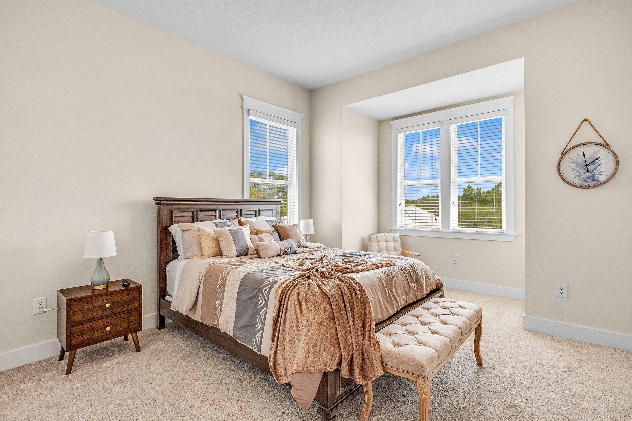 79 Grande Pointe Drive Inlet Beach, FL 32461 - Photo 28 of 47 a bed sitting in a bedroom next to a window and a chair