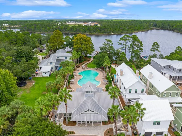 an aerial view of residential houses with outdoor space and river
