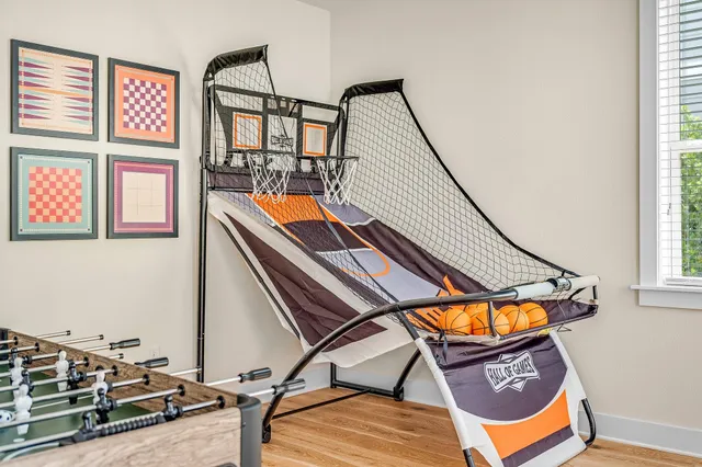 a living room with furniture kitchen view and a window