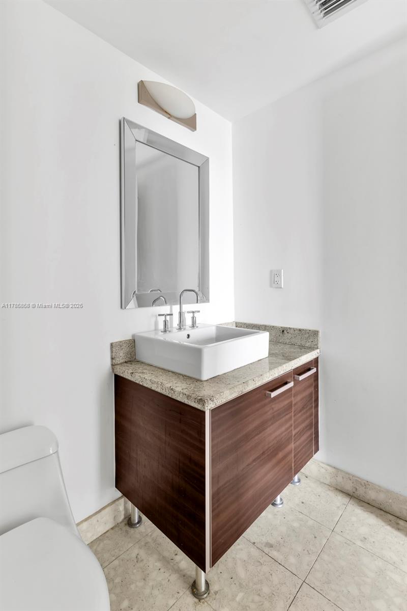 185 Southwest 7th Street, Unit 1508 Miami, FL 33130 - Photo 15 of 30 a bathroom with a sink vanity and toilet