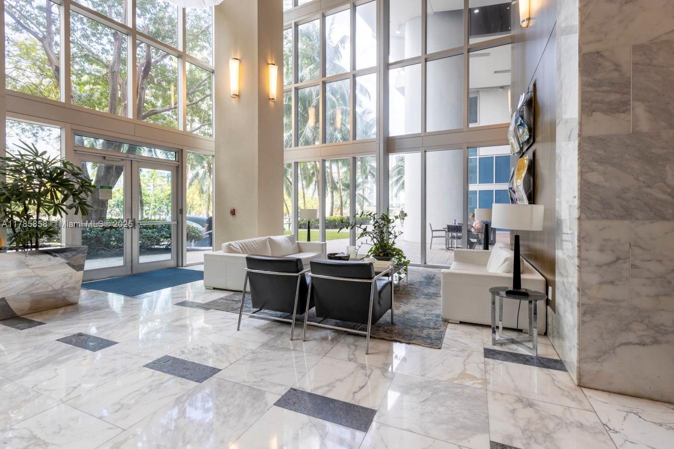 185 Southwest 7th Street, Unit 1508 Miami, FL 33130 - Photo 16 of 30 a living room with furniture and a large window
