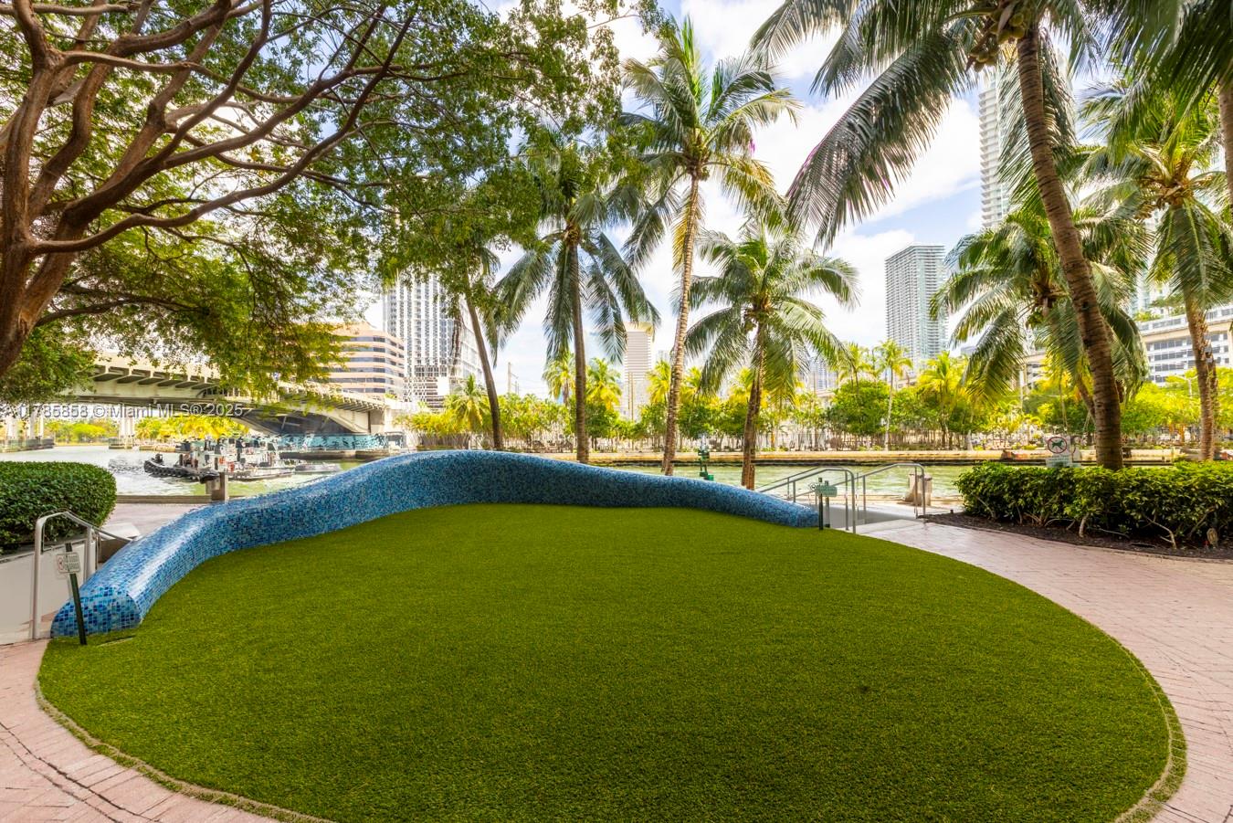 185 Southwest 7th Street, Unit 1508 Miami, FL 33130 - Photo 22 of 30 a view of a swimming pool with an outdoor space and seating area