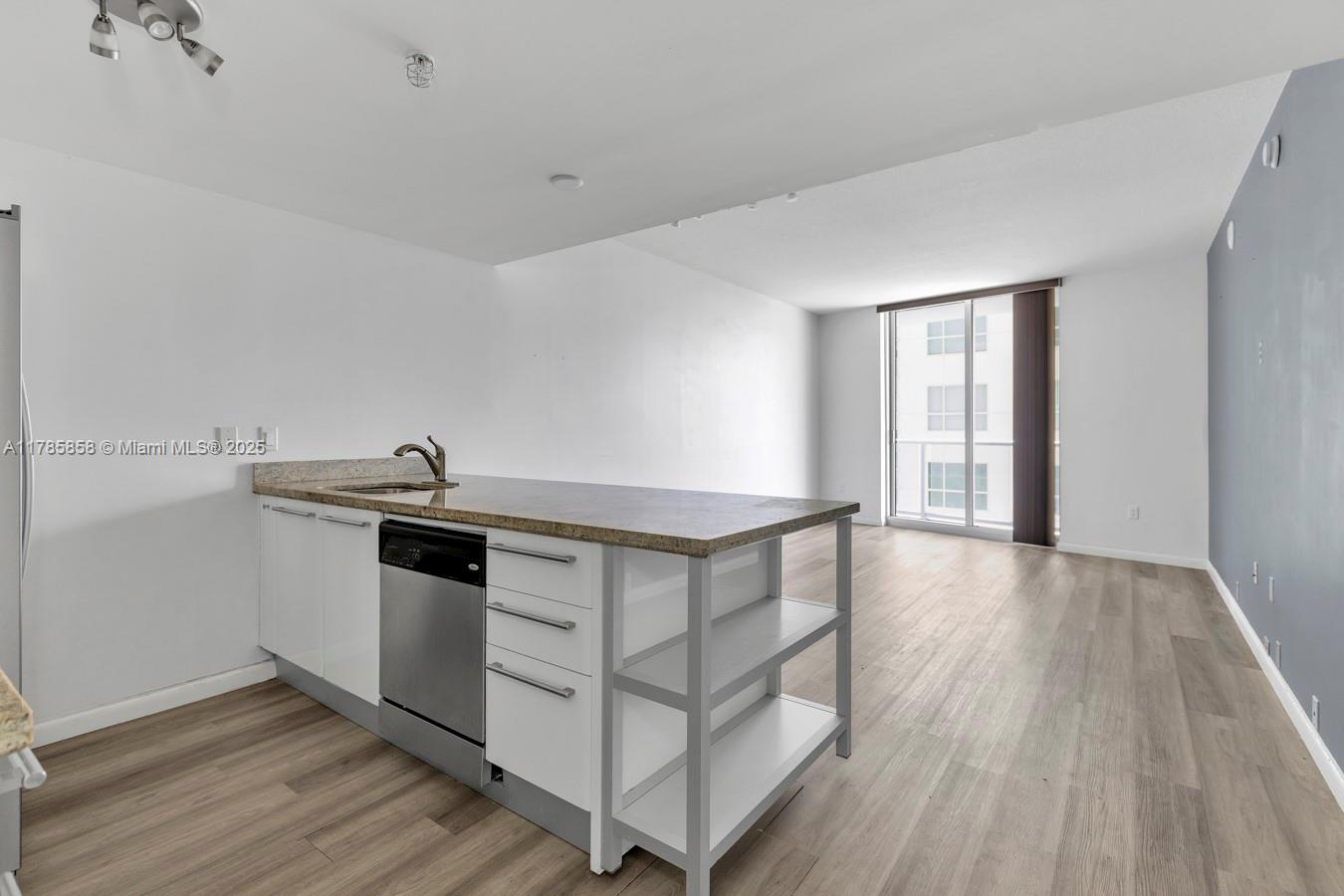 185 Southwest 7th Street, Unit 1508 Miami, FL 33130 - Photo 4 of 30 a view of kitchen with sink and wooden floor