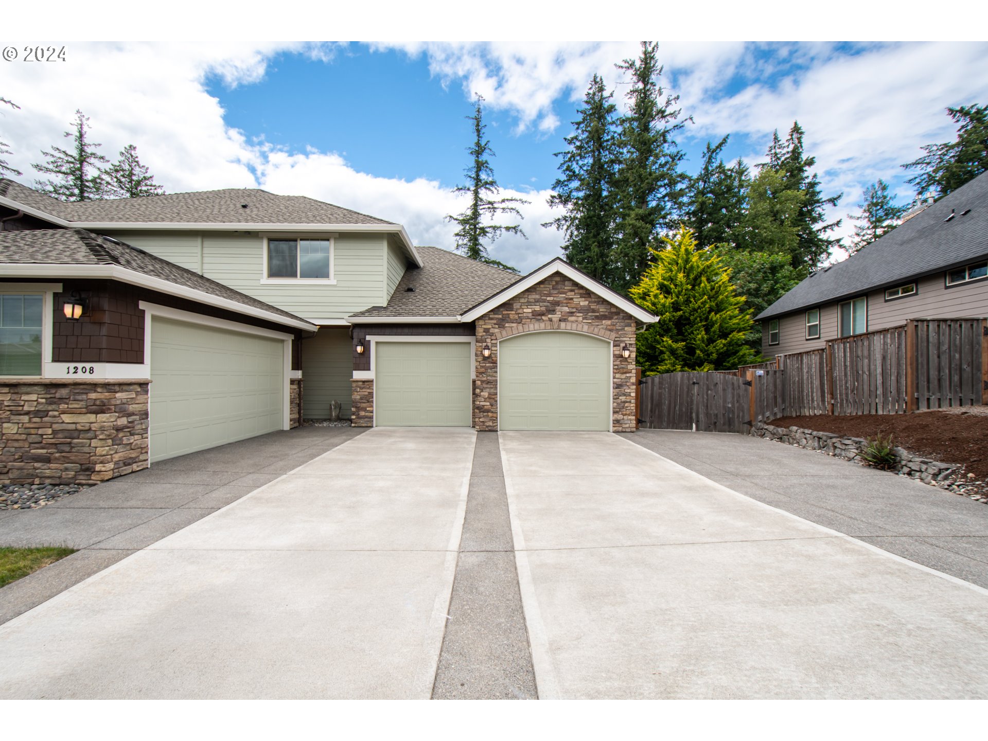 1208 South Great Blue Road Ridgefield, WA 98642 - Photo 48 of 48 a front view of a house with a yard and garage